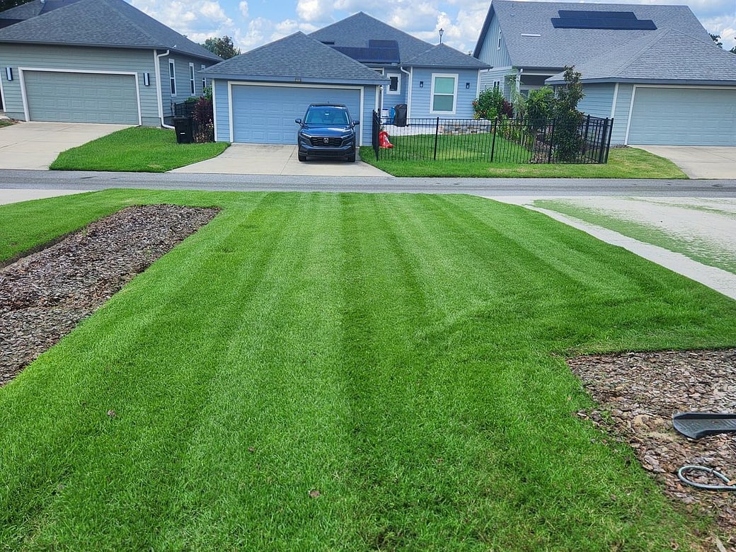A freshly striped, freshly mowed residential front lawn