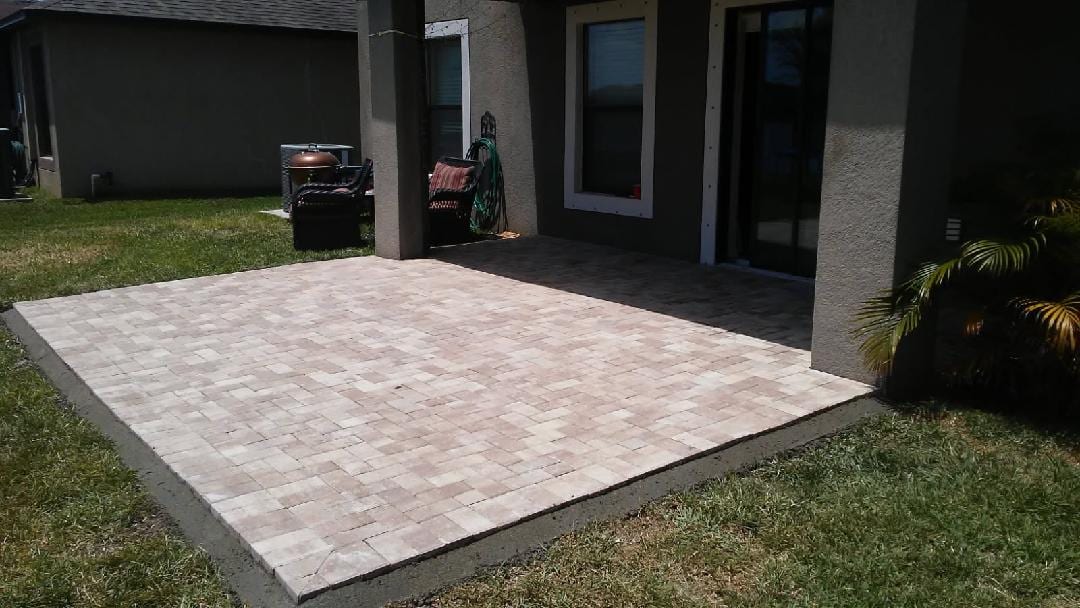 A finished paver patio under a covered porch at a Florida home