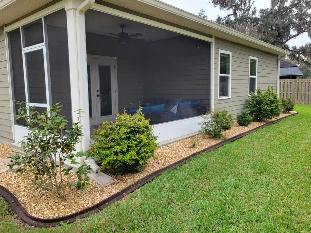 A planting bed along the exterior of a screened porch