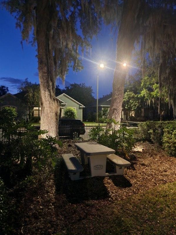 Landscape lighting along a community picnic area at night