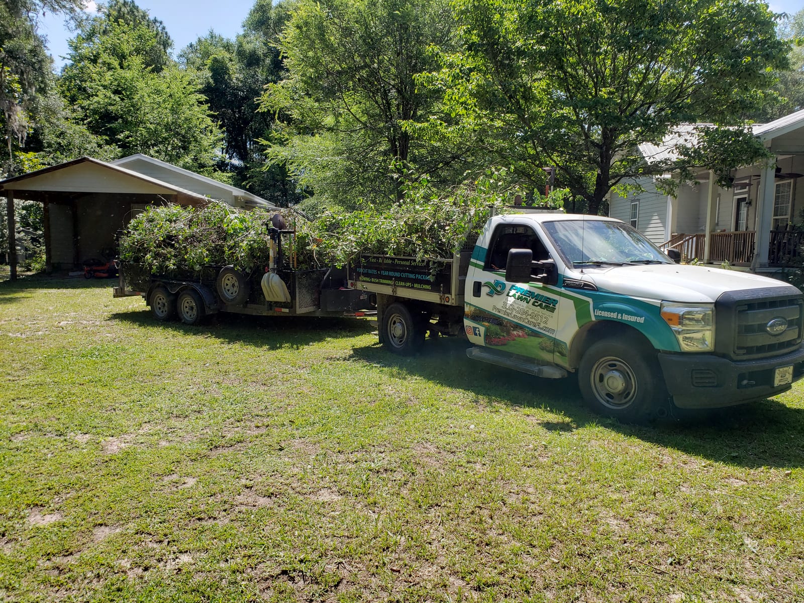 A truck and trailer loaded with cleared yard debris